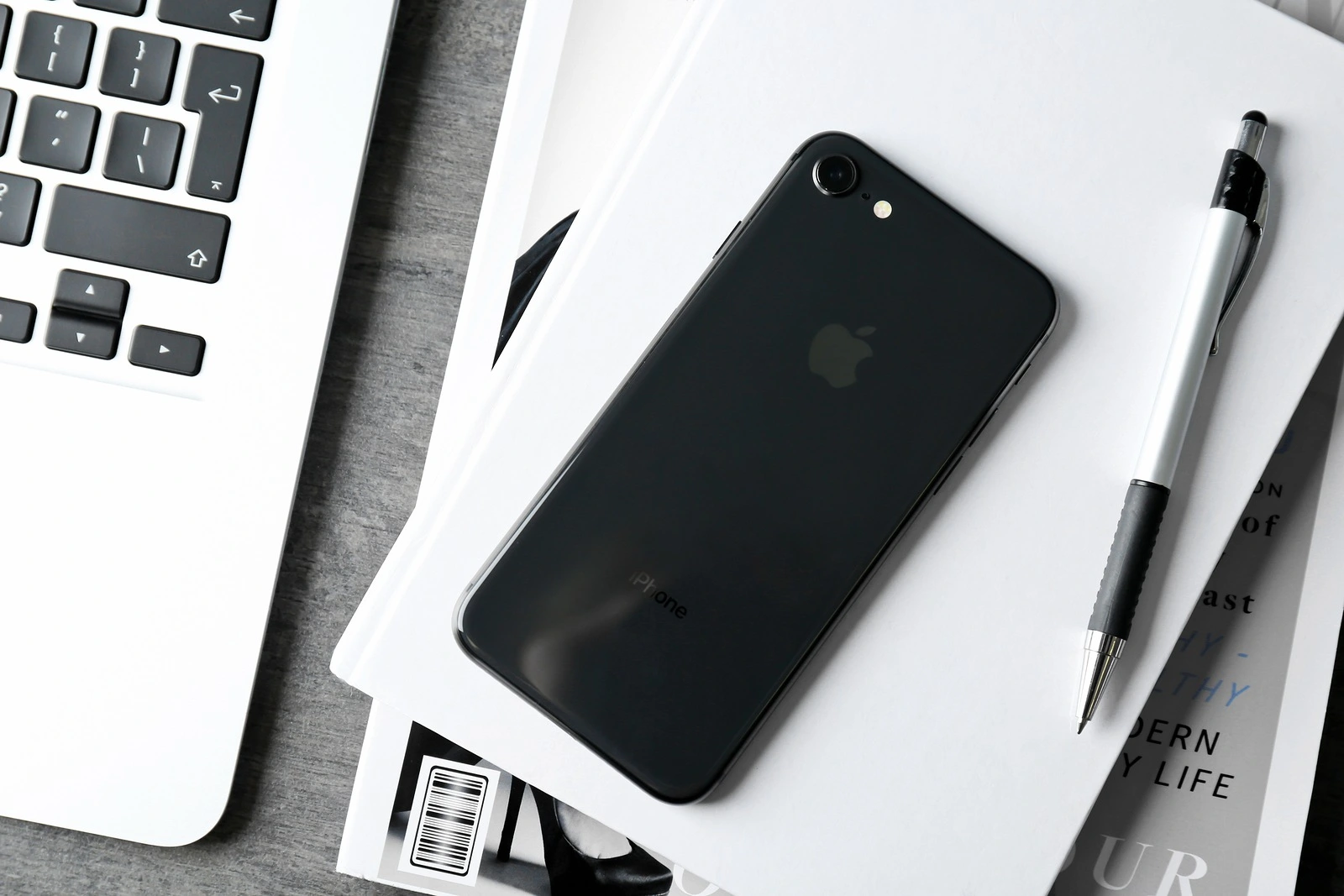 KYIV, UKRAINE - DECEMBER 5, 2017: Back panel of iPhone 8 Space Gray on notebook