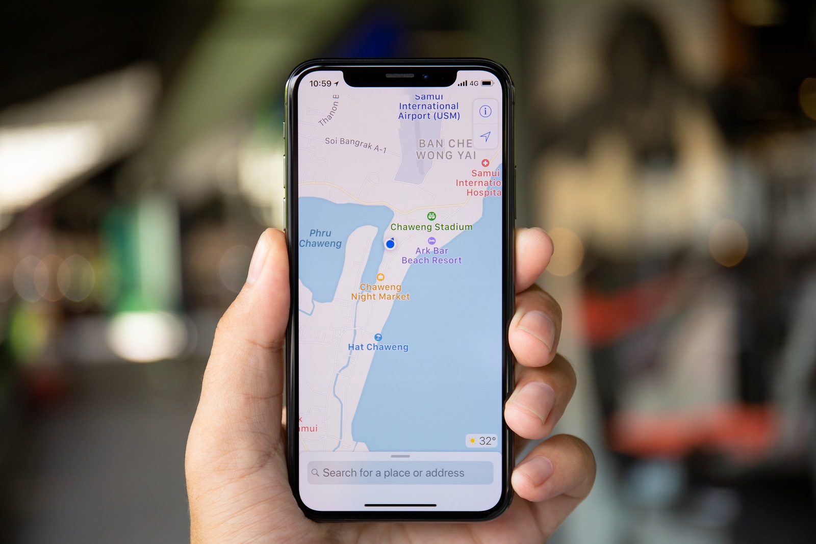 Koh Samui, Thailand - April 15, 2018: Man hands holding iPhone X with application cartographic service Apple Maps in the screen. iPhone 10 was created and developed by the Apple inc.