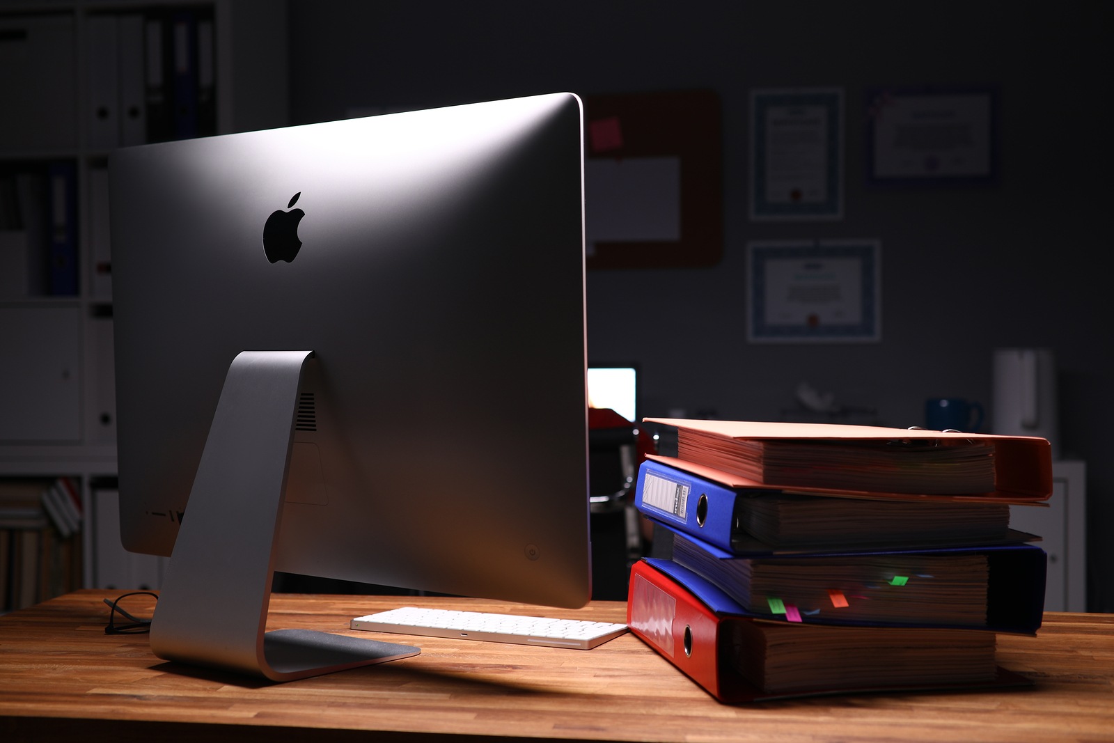 Minsk, Belarus - December 5, 2019: Apple imac computer aganist empty office background. Illustrative editorial image.