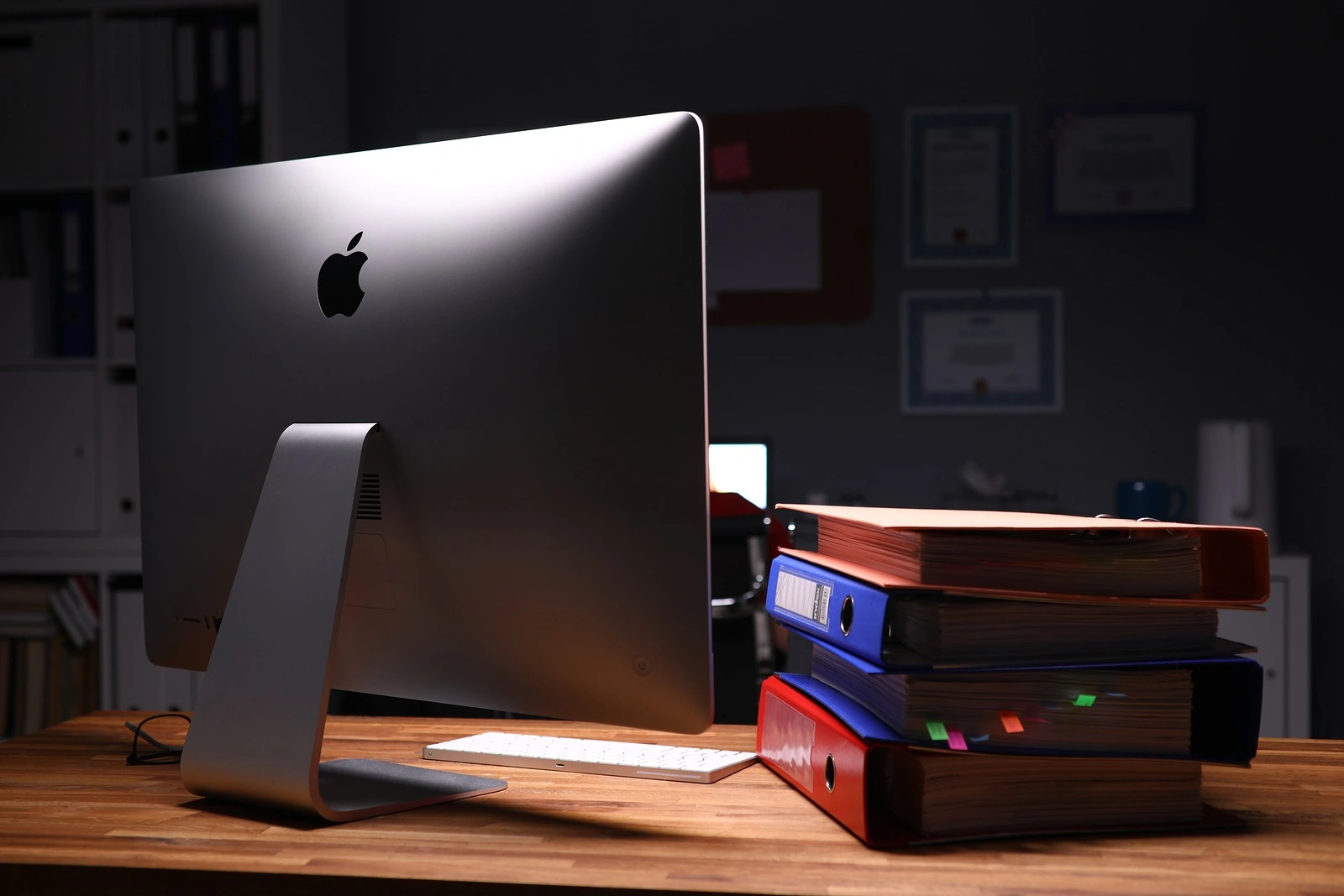 Minsk, Belarus - December 5, 2019: Apple imac computer aganist empty office background. Illustrative editorial image.