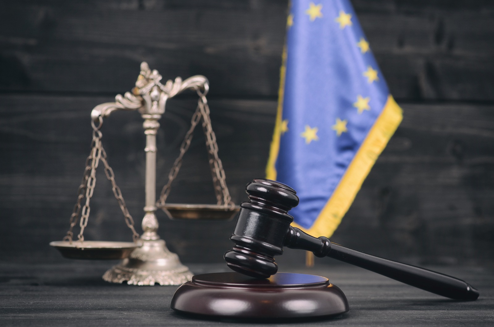 Law and Justice , Legality concept, Scales of Justice, Judge Gavel and Flag of the European Union on a black wooden background.