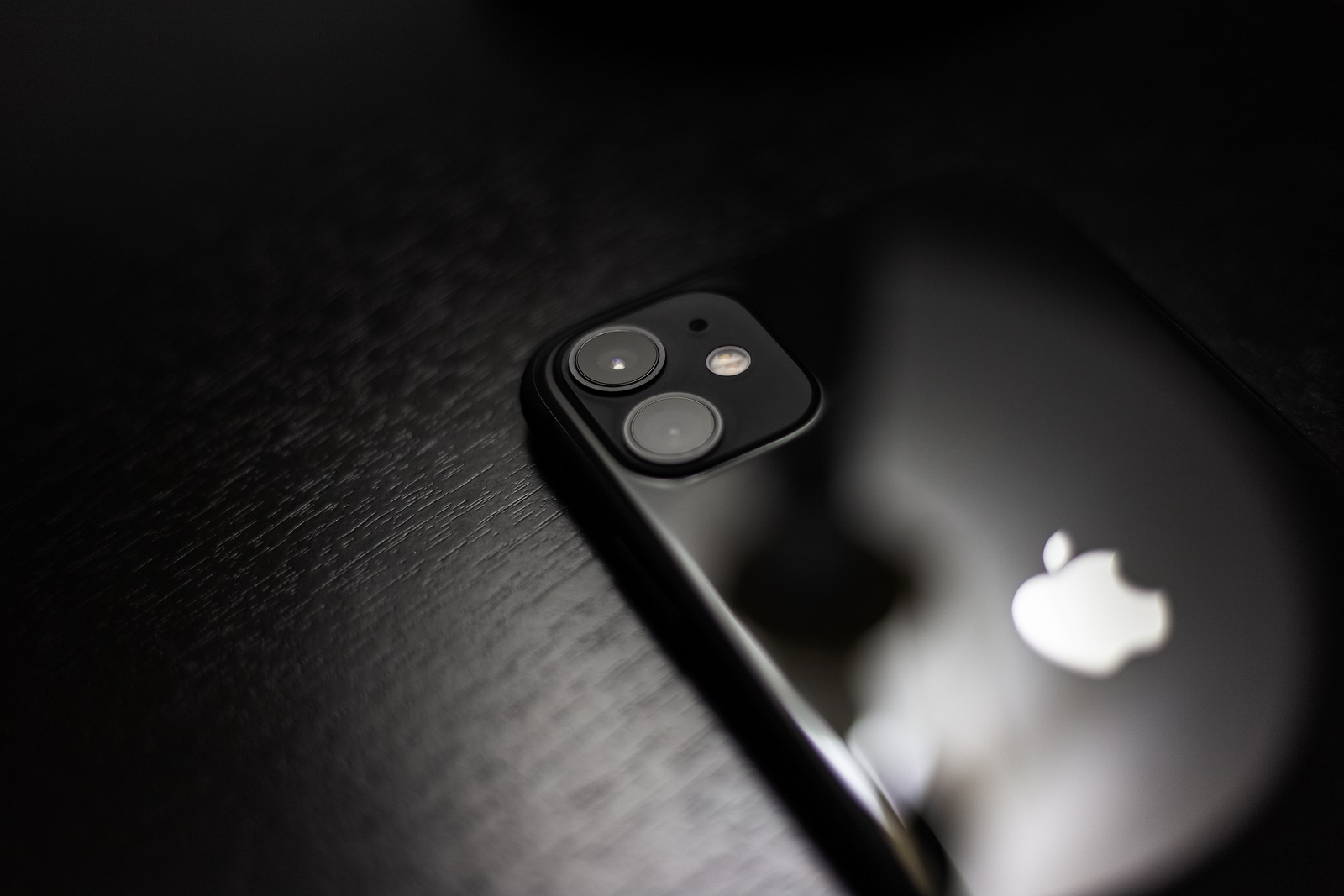 Moldova, Chisinau - November 3, 2019: Close-up of black iPhone 11 on dark wooden table.