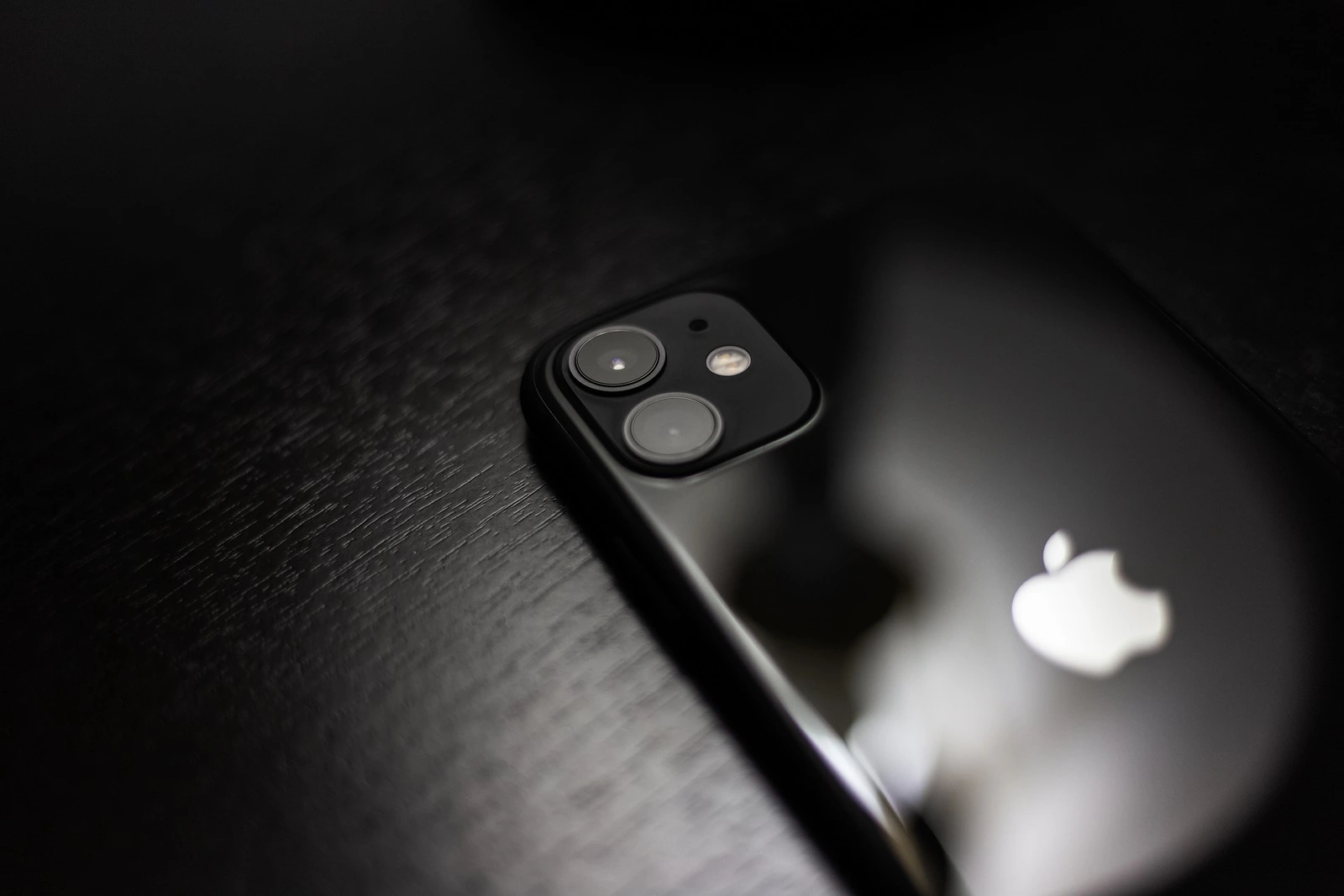 Moldova, Chisinau - November 3, 2019: Close-up of black iPhone 11 on dark wooden table.