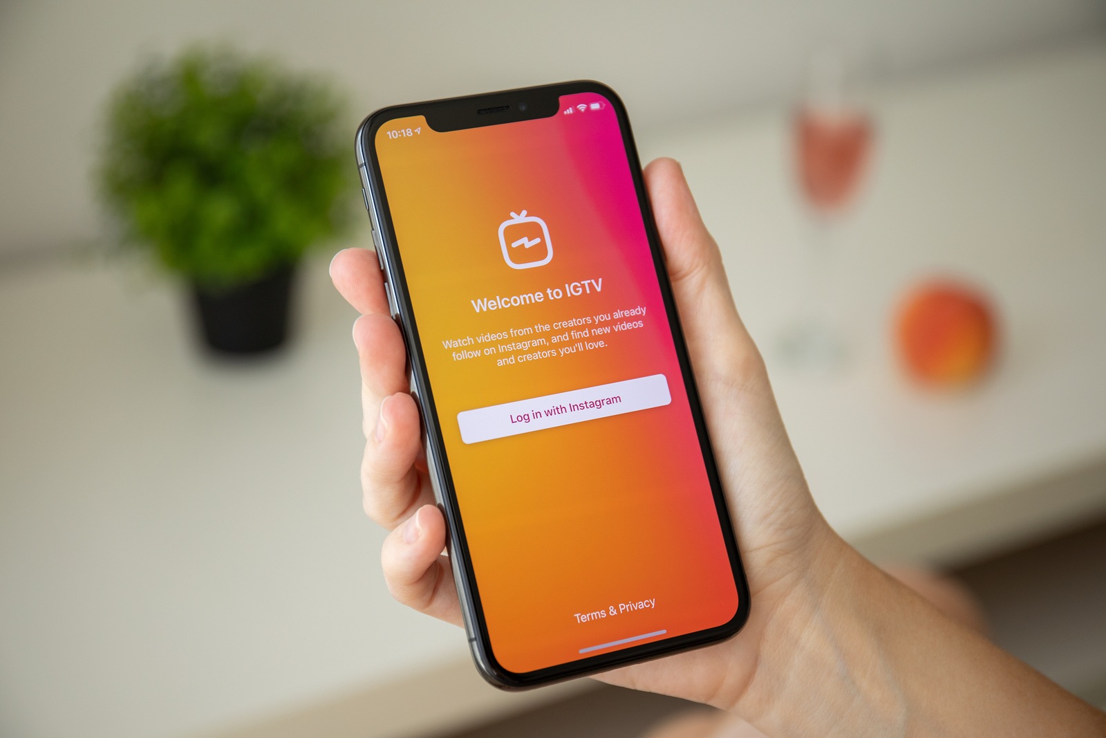 Anapa, Russia - July 29, 2018: Woman hand holding iPhone X with social networking service IGTV Instagram on the screen. iPhone ten was created and developed by the Apple inc.