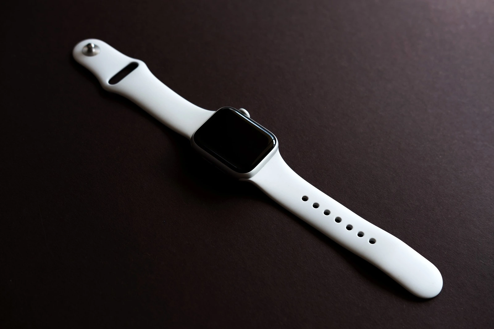 Chekhov, Russia - July 19, 2019: Apple Watch Series 4 white color. A new watch from an Apple company closeup isolated on dark background