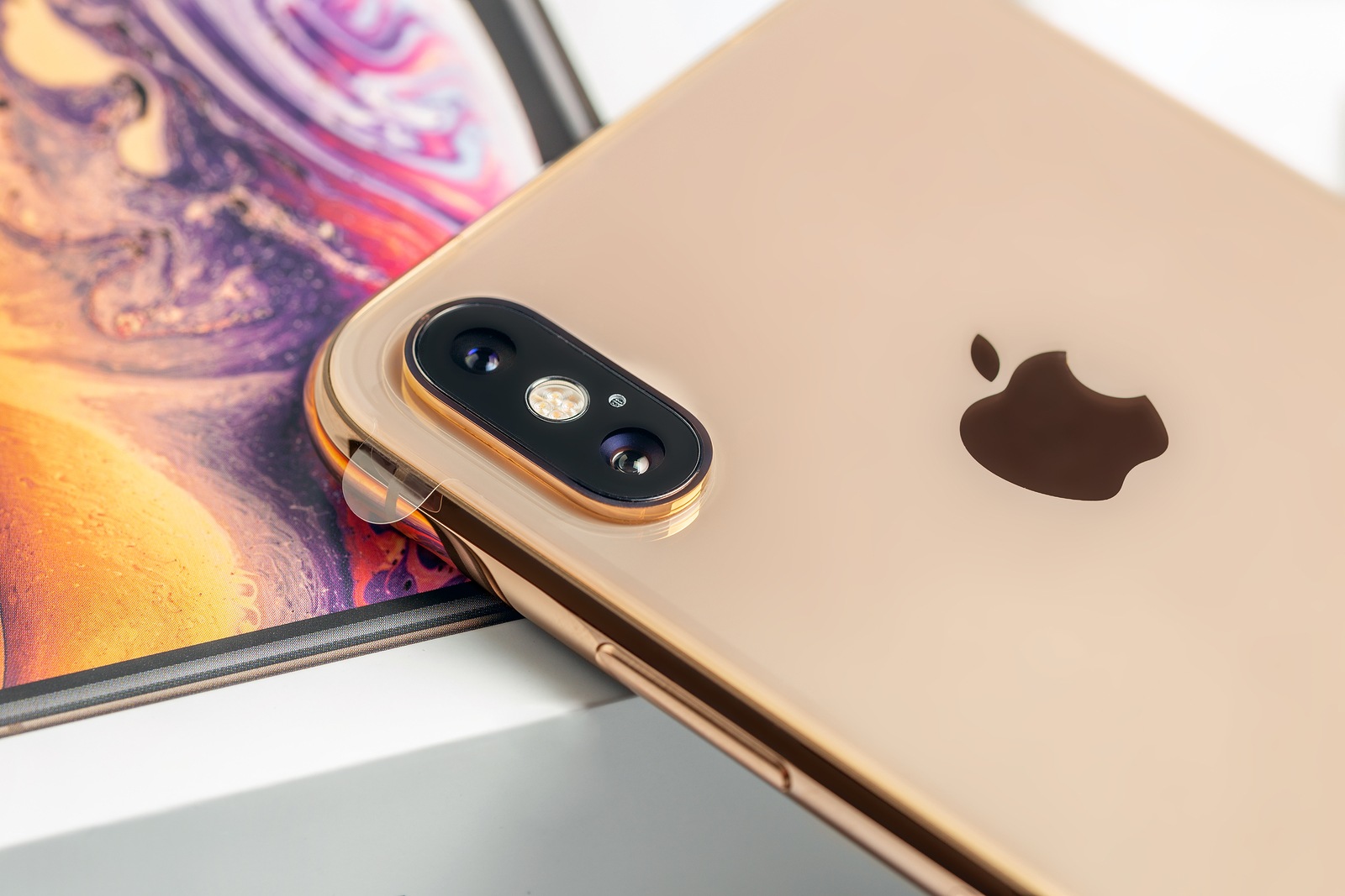 12th October, 2018-Kiev, Ukraine: Latest iPhone XS on opened box on white table. Newest Apple smartphone on white branded box in mobile store. Modern gadget with dual camera and OLED screen for sale