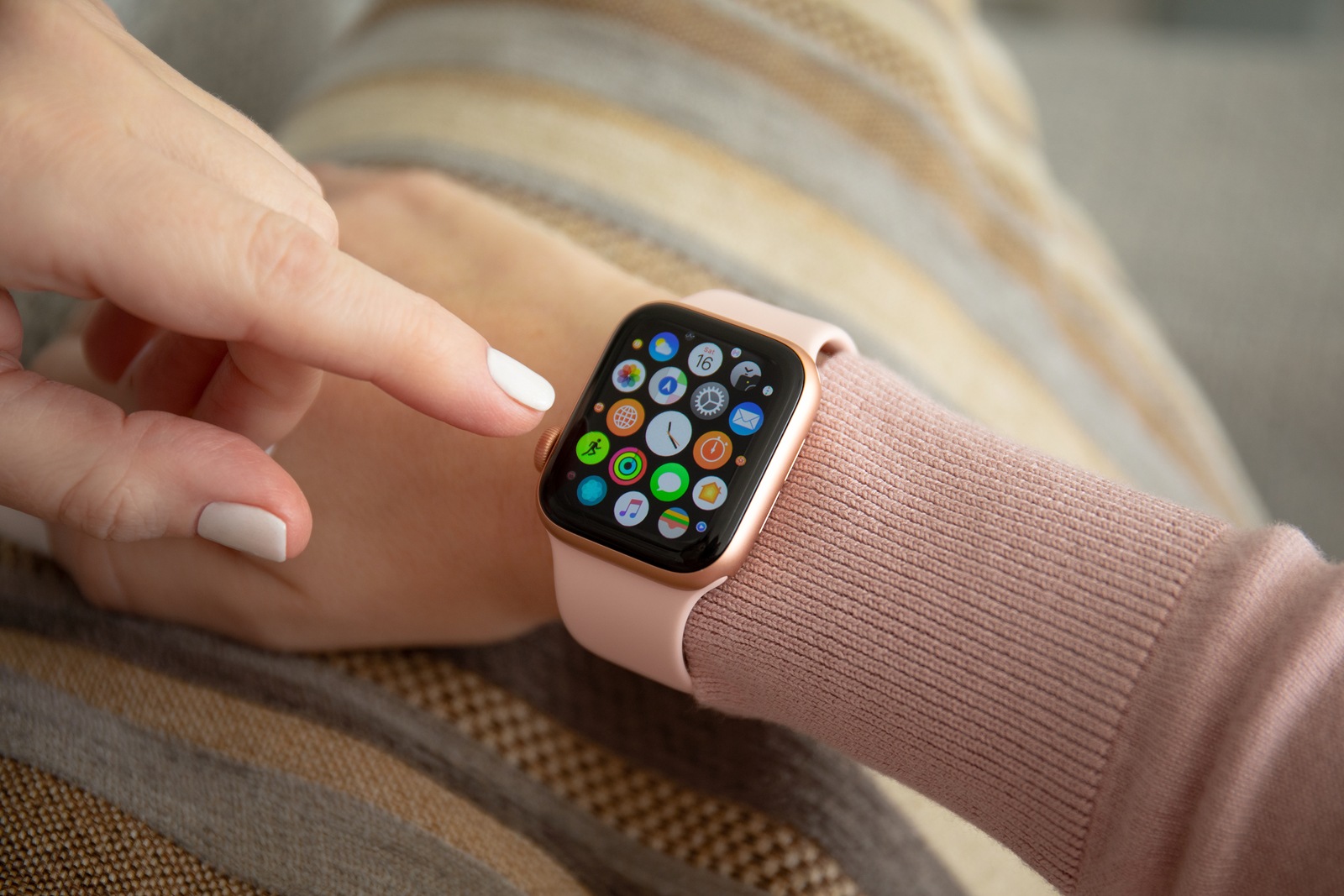 Anapa, Russia - February 16, 2019: Woman hand with Apple Watch Series 4 and finger touching screen. Apple Watch was created and developed by the Apple inc.