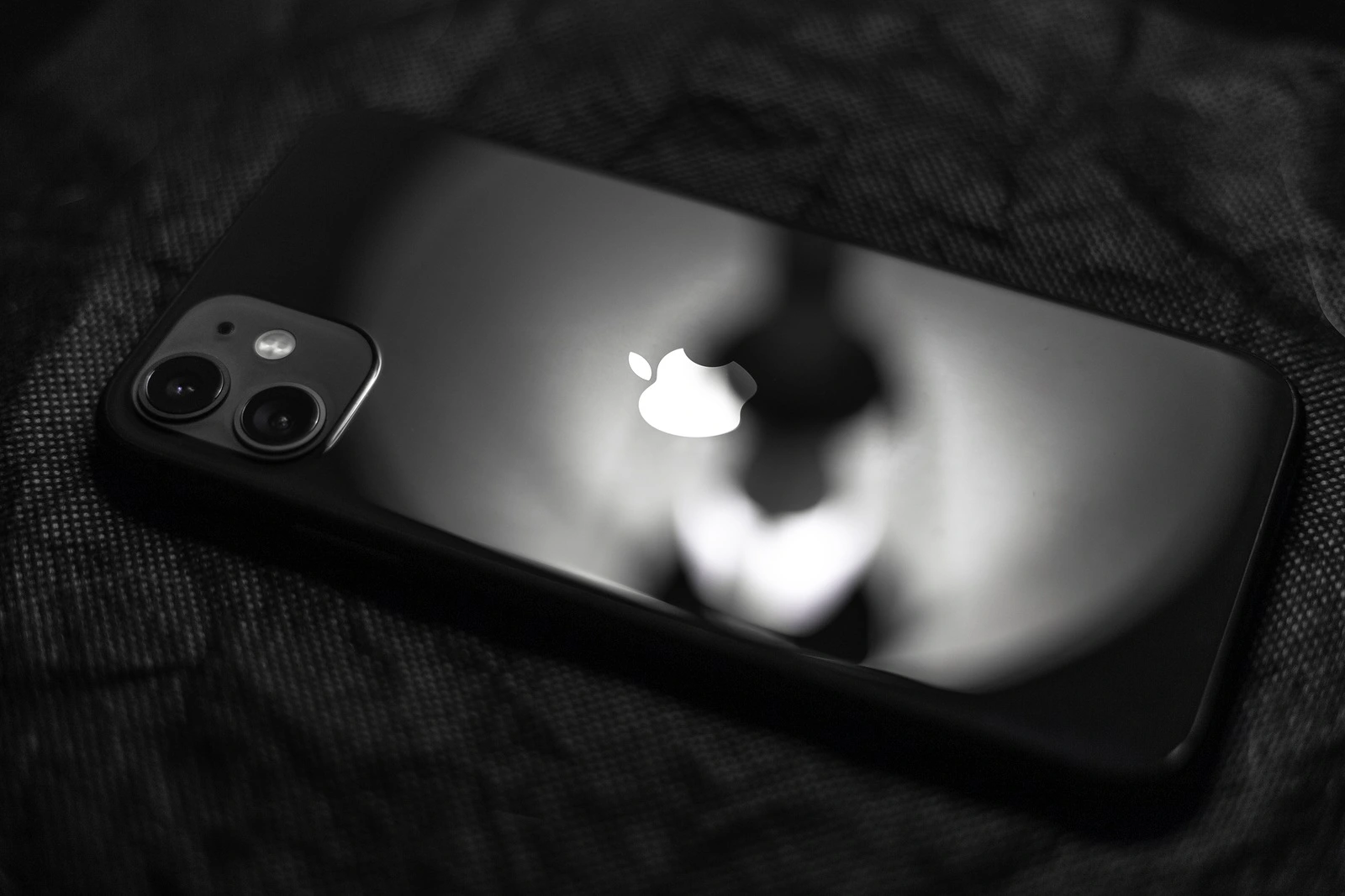 Moldova, Chisinau - November 3, 2019: Close-up of black iPhone 11 on dark textured background.