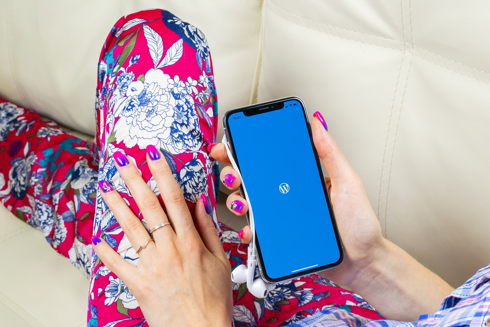 Sankt-Petersburg, Russia, June 8, 2018: Wordpress application icon on Apple iPhone X screen close-up in woman hands. Wordpress app icon. Wordpress.com application. Social networks