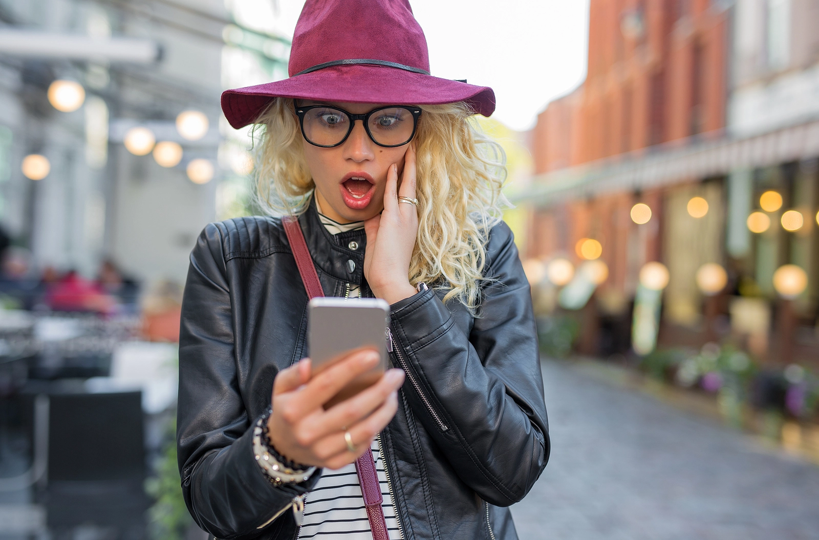 Woman looking at her phone in shock