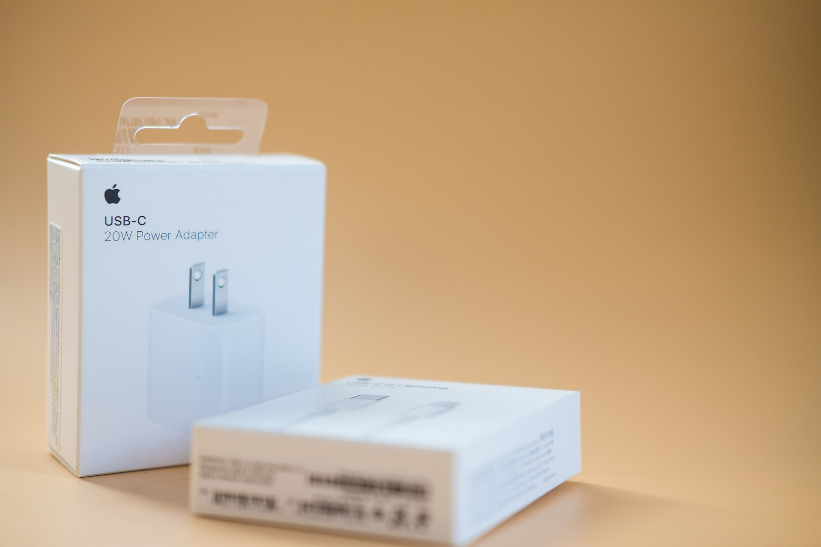 Bangkok - January 16, 2022 : A box of High power USB-C power adapter 20w by Apple on an orange surface with copy space