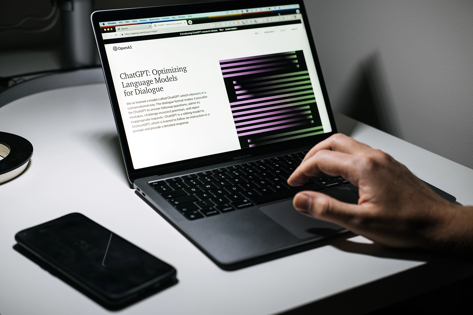 Screen with ChatGPT chat with AI or artificial intelligence. Man search for information using artificial intelligence chatbot developed by OpenAI. Warsaw, Poland - December 02, 2022
