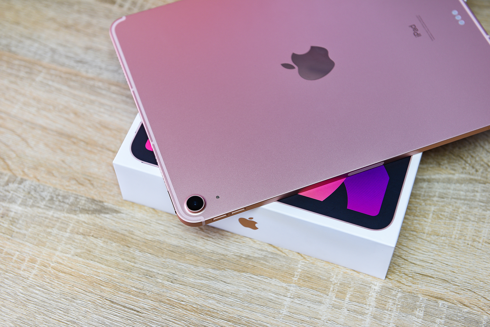 Bangkok, Thailand - August 21, 2021: New Apple iPad rose gold color, camera and rear view logo Apple launch Tablet iPad Air 2020-2021 (4th Gen.) with box on white background