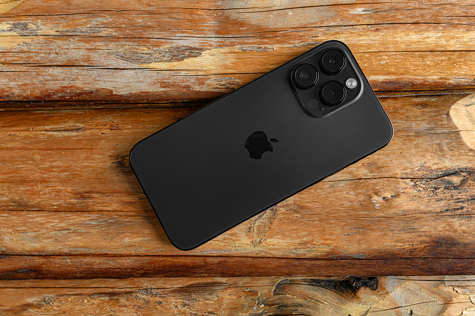 Uzhgorod, Ukraine - May 05, 2023: New Apple iPhone 14 Pro Max Space Black on a wooden background.