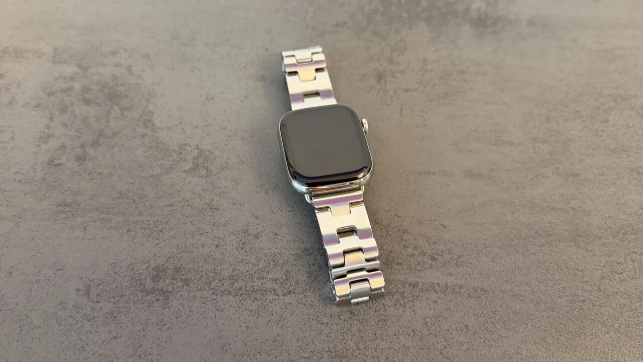 Apple Watch GPS or Cellular: Apple Watch with a silver link bracelet on a grey stone surface