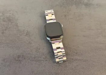 Apple Watch GPS or Cellular: Apple Watch with a silver link bracelet on a grey stone surface