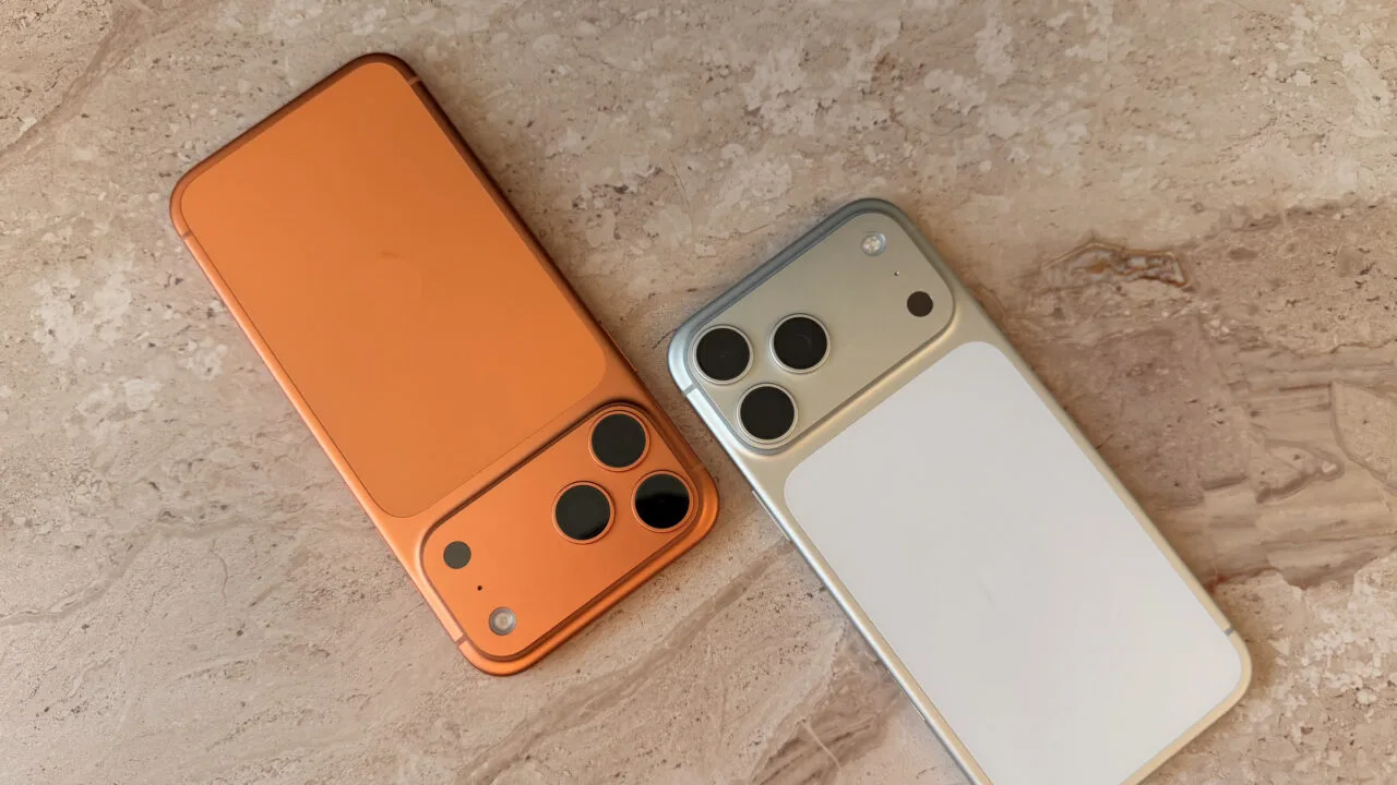Two iPhones lying side by side on a light stone surface, the starting point when transferring data to a new iPhone