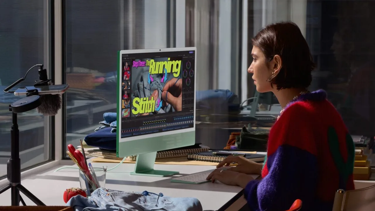Video editing on a green iMac: a woman works on a sewing video, a typical use case for the iMac M6