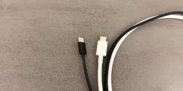 USB-C cable for Mac: a black braided USB-C cable without markings next to a white cable with the Thunderbolt logo on its connector