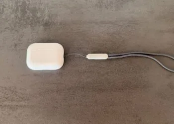 AirPods Pro 3 in white with closed charging case against a dark background