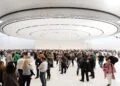 Guests in the lobby of the Steve Jobs Theater beneath the circular ceiling element, venue for the keynote at Apple's September event