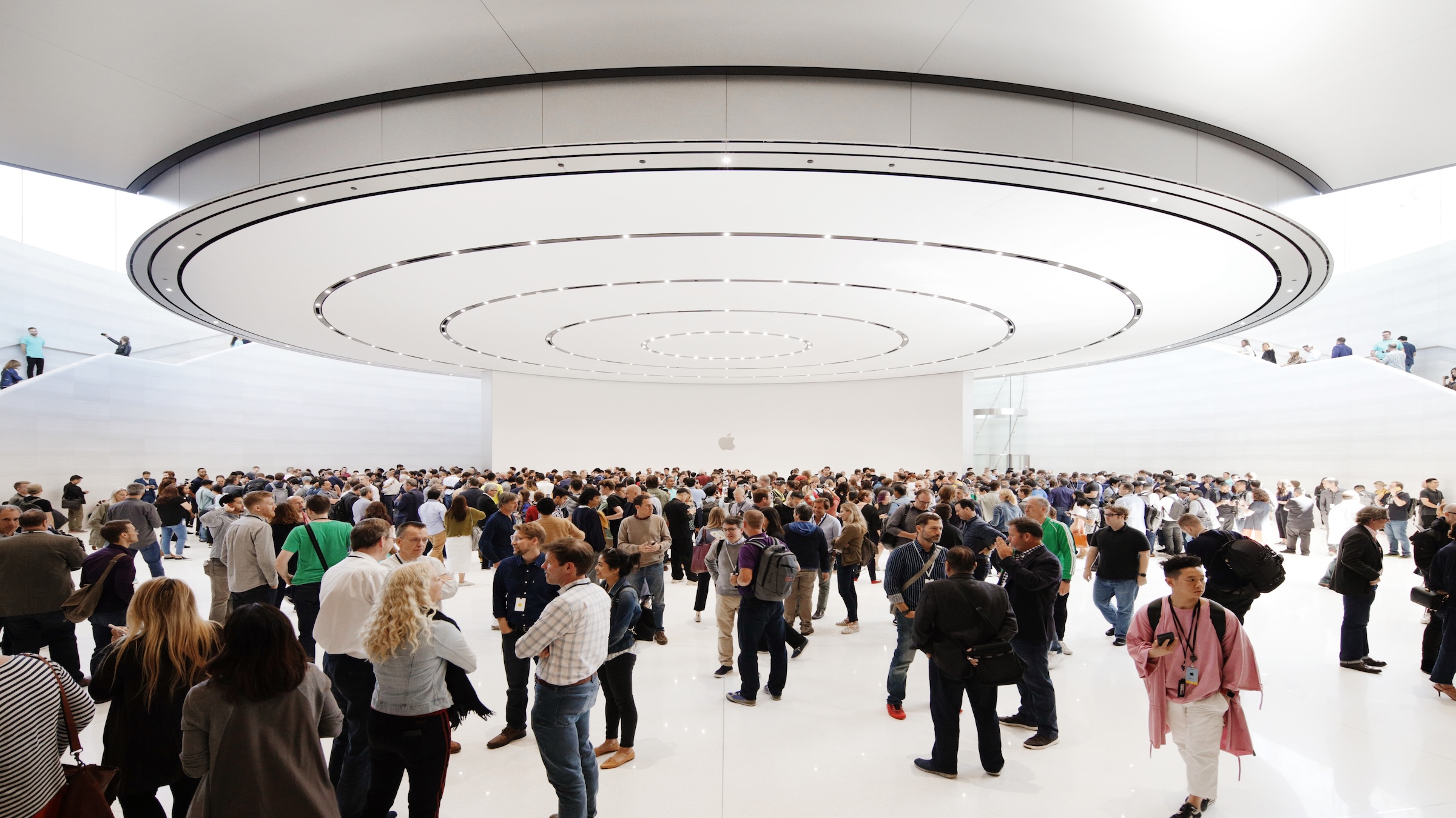 Guests in the lobby of the Steve Jobs Theater beneath the circular ceiling element, venue for the keynote at Apple's September event