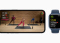Apple Fitness+ training on an iPhone with three trainers in the studio, next to an Apple Watch displaying heart rate and calorie values