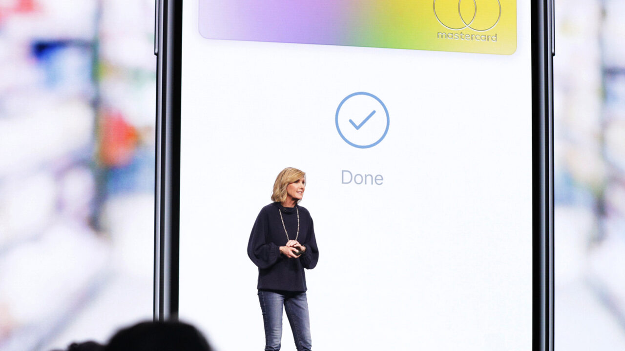 Jennifer Bailey on stage at an Apple event in front of a projected Apple Card, the Apple Pay chief is leaving the company in October
