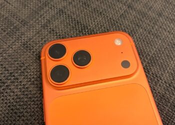 Camera plateau of an iPhone 17 Pro Max in Cosmic Orange, whose image sensor carries the provenance data for Apple Reference Image