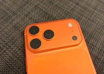 Camera plateau of an iPhone 17 Pro Max in Cosmic Orange, whose image sensor carries the provenance data for Apple Reference Image