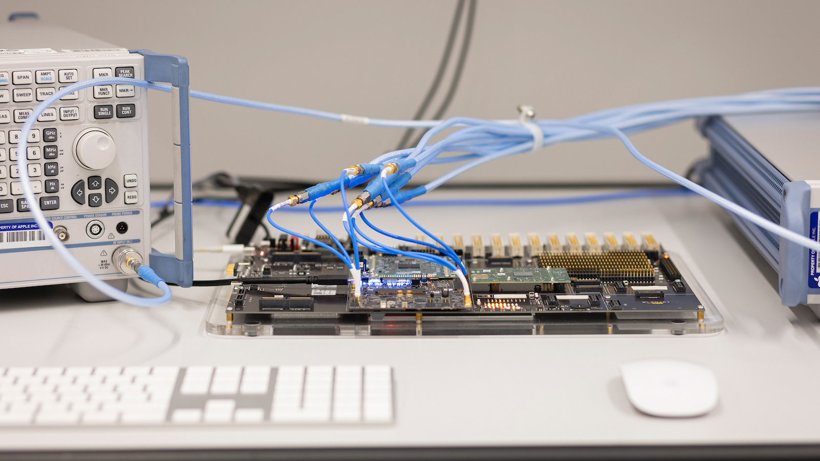 Symbolic image for Apple China memory: test setup with circuit board and analyzer at Apple's Silicon Design Center in Munich