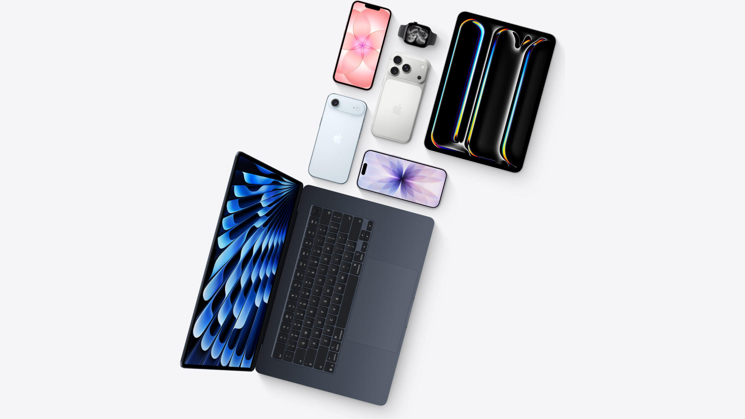 Overhead arrangement of a MacBook, iPad, several iPhones and an Apple Watch as offered through the Apple Upgrade leasing program