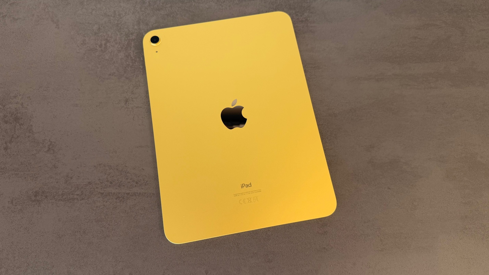 Tenth-generation iPad in yellow lying face down on a dark surface, iPad shipments declined in the second quarter