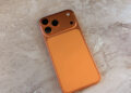 Back of an iPhone 17 Pro Max in Cosmic Orange showing the camera module, which is expected to gain a variable aperture on the iPhone 18 Pro Max