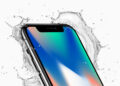 The iPhone X surrounded by splashing water on a light background, now classified as obsolete by Apple