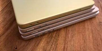 Four stacked MacBooks seen from the port side with MagSafe 3 and USB-C, where each model needs a different MacBook power adapter for full charging speed