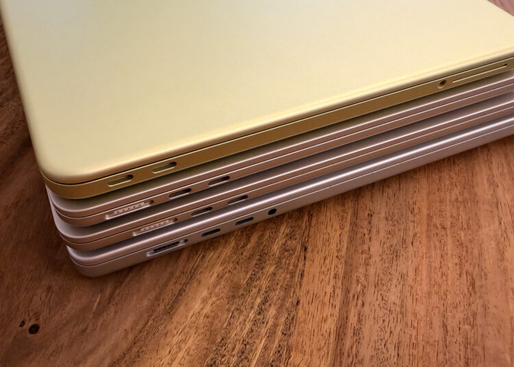 Four stacked MacBooks seen from the port side with MagSafe 3 and USB-C, where each model needs a different MacBook power adapter for full charging speed