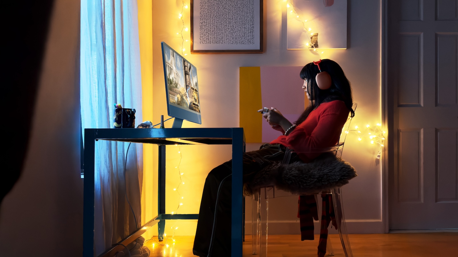 Blue 24-inch iMac on a desk in a dimly lit room, the display technology that could switch to five emitting layers in an OLED iMac