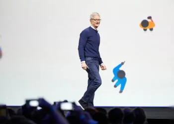 Tim Cook walking across the stage at an Apple developer conference – taking stock after 15 years as Apple CEO