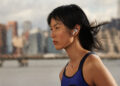 Runner wearing AirPods in the rain, earbuds are the largest category in the wearables market