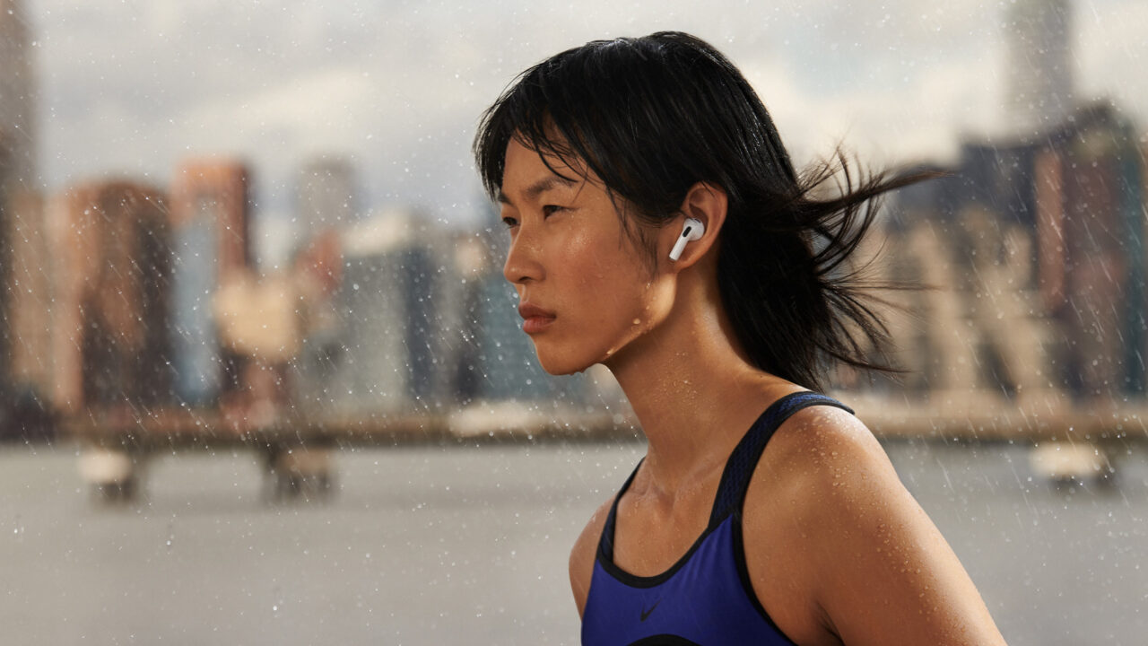 Runner wearing AirPods in the rain, earbuds are the largest category in the wearables market