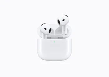 AirPods 5 in the open charging case with a green charge indicator on a light background