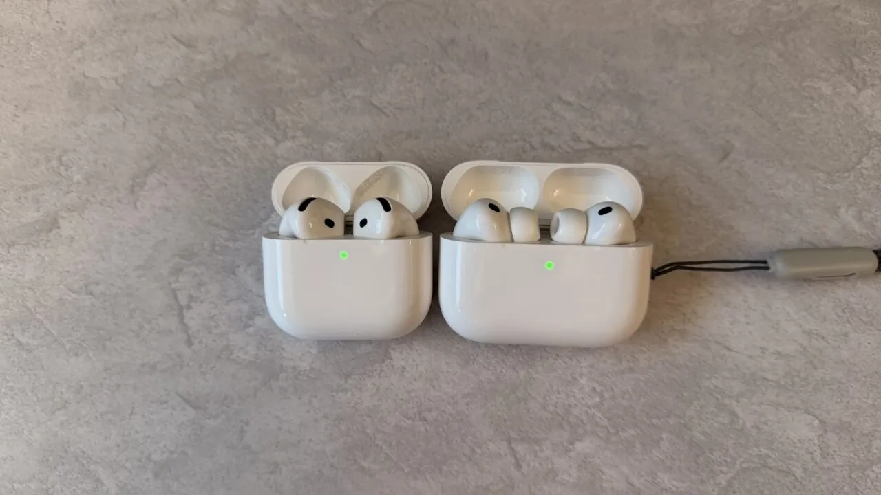 Two open AirPods charging cases side by side: AirPods without silicone ear tips on the left, AirPods Pro with silicone ear tips on the right