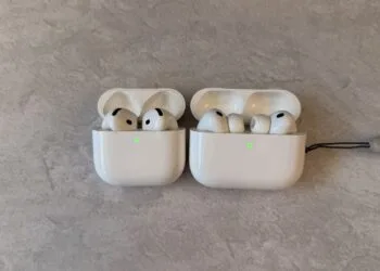 Two open AirPods charging cases side by side: AirPods without silicone ear tips on the left, AirPods Pro with silicone ear tips on the right