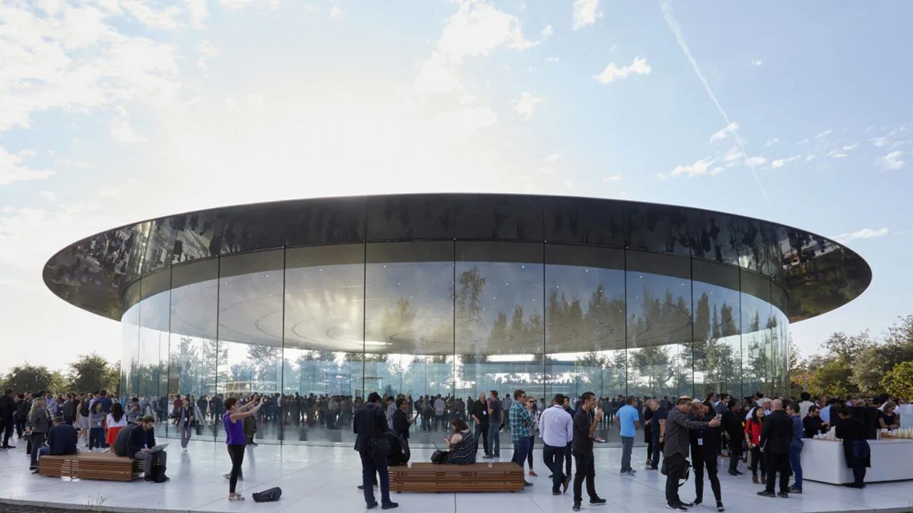 Crowd outside the glass Steve Jobs Theater at Apple Park; the iPhone 18 Pro event can be watched live worldwide