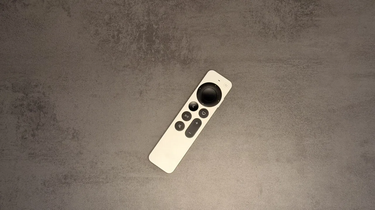 New Apple TV 4K: silver Siri Remote lying diagonally on a grey stone surface