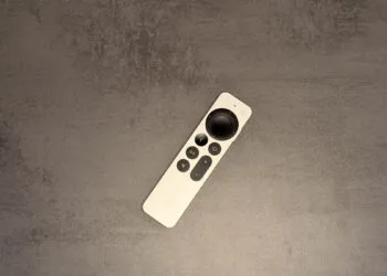 New Apple TV 4K: silver Siri Remote lying diagonally on a grey stone surface