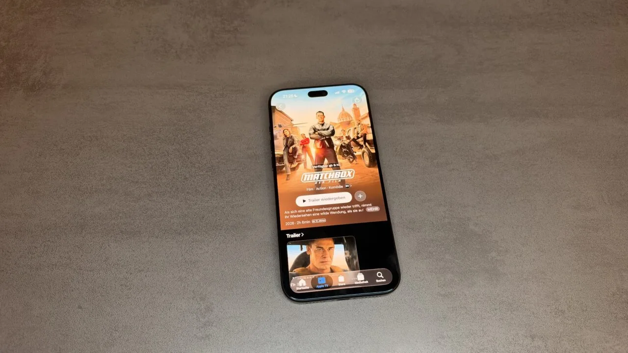 Apple TV October 2026: iPhone on a grey stone surface showing the Matchbox The Movie page in the Apple TV app with the note available from October 9