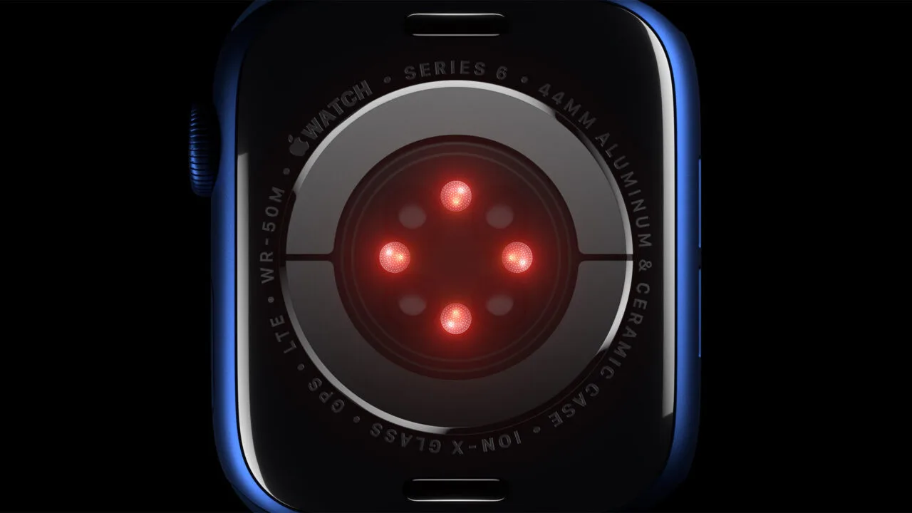 Apple Sonera acquisition: sensor array on the back of an Apple Watch Series 6 with glowing red diodes