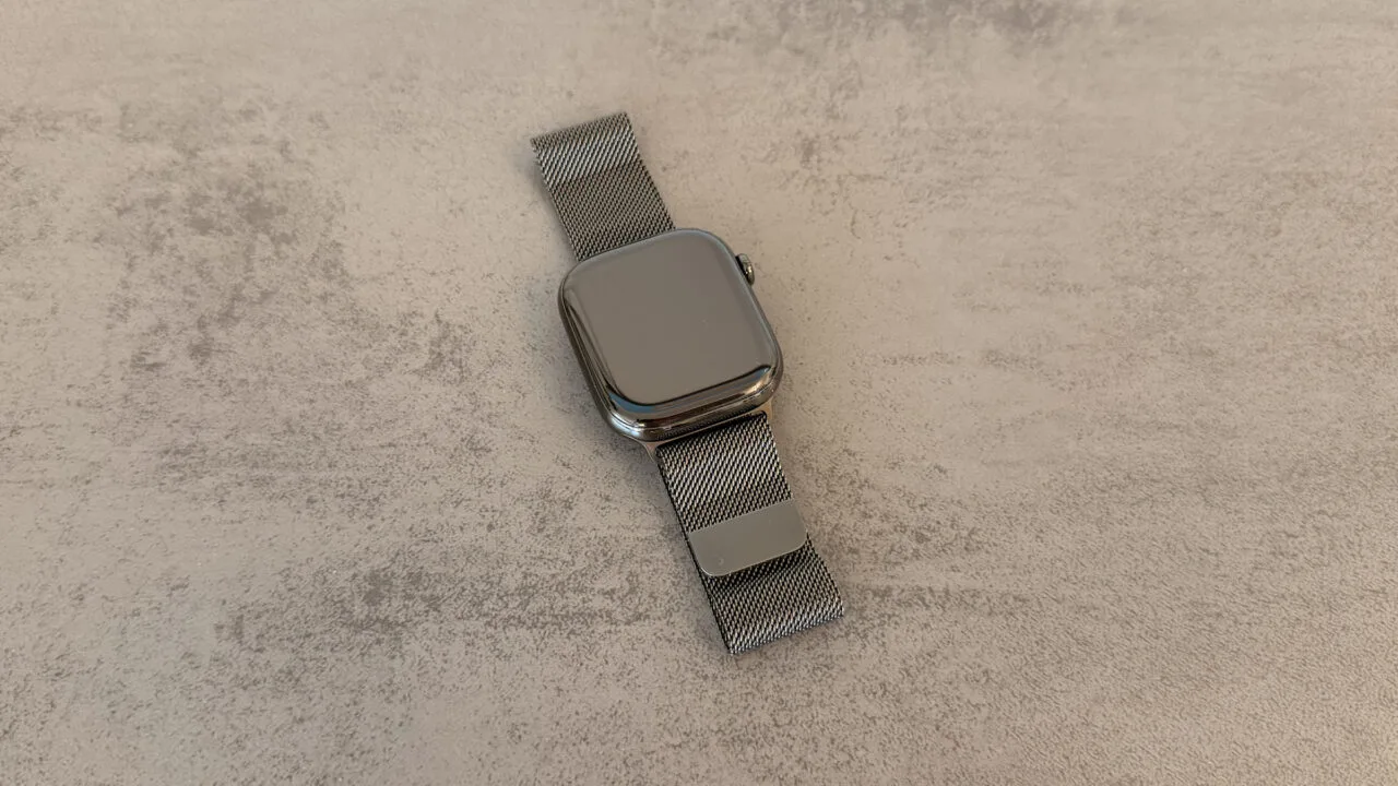 Apple Watch with Milanese loop on a light stone surface, related to the Apple Watch Series 12 code findings